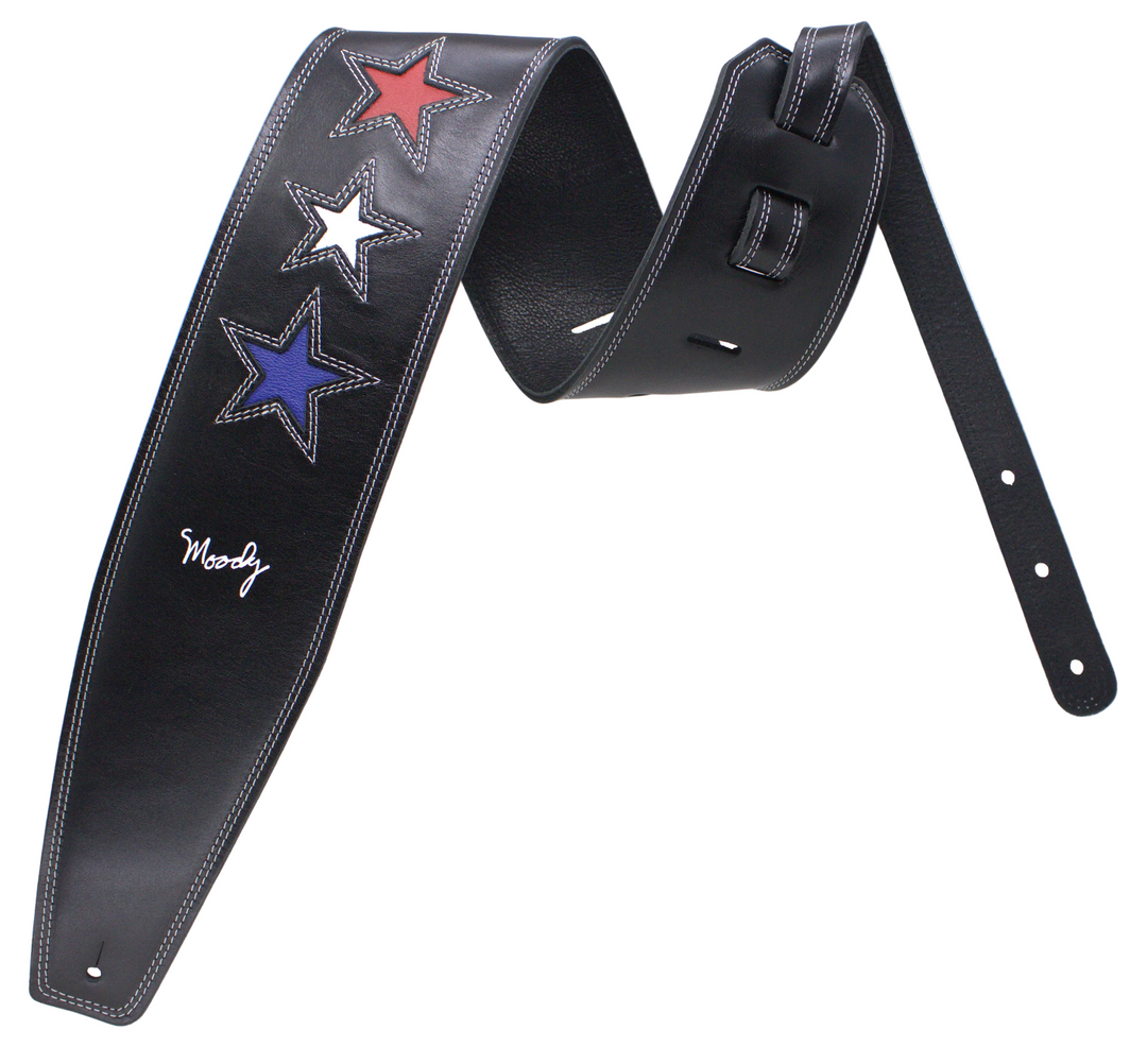 A black leather guitar strap featuring three embroidered stars in red, white, and blue, with a white script signature reading 'Moody', displayed against a white studio background.
